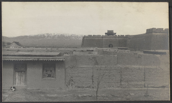 Yu Wang. South Gate with snow-covered Lo Shan in background. Our inn in foreground.