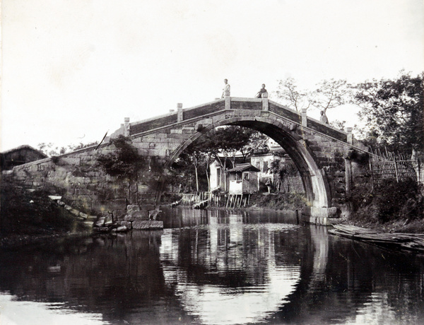 View of river houses seen through a bridge