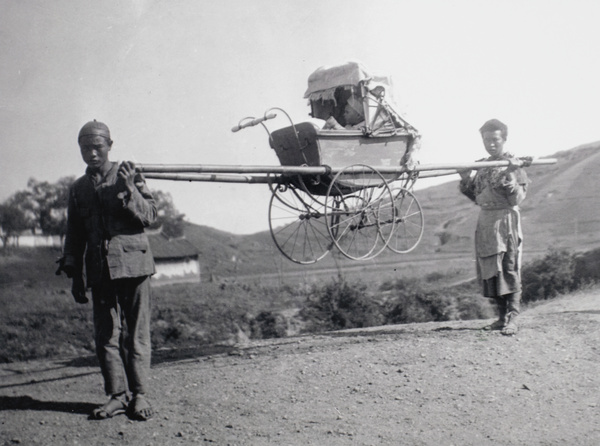 Bearers carrying a baby in a pram