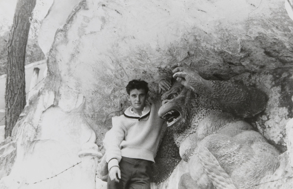 Man posed beside sculpture of a gorilla, Tiger Balm Garden, Hong Kong