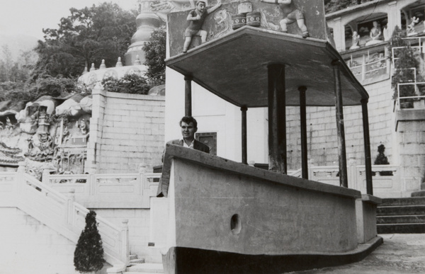 Man sitting in a 'boat', Tiger Balm Garden, Hong Kong