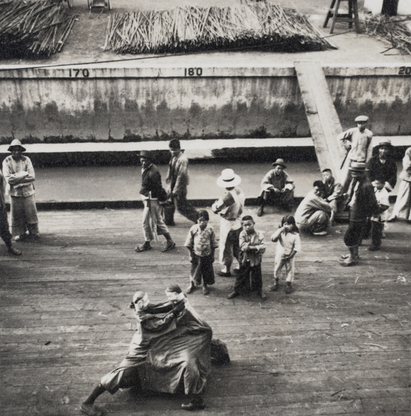 A performance on a quay, with spectators, Shanghai