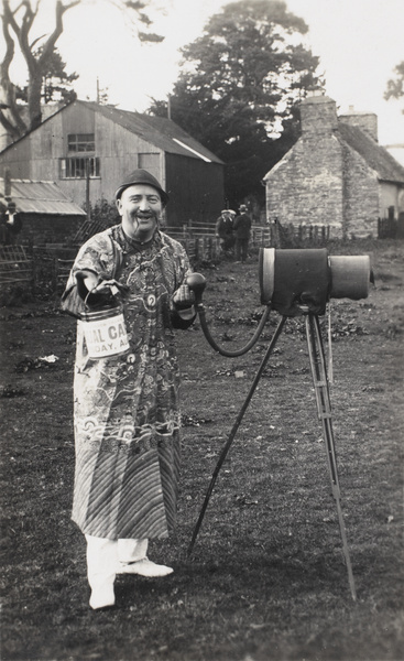 A man in fancy dress, as a Chinese photographer, Rhayader Carnival, Wales (Carnifal Rhaeadr, Cymru)