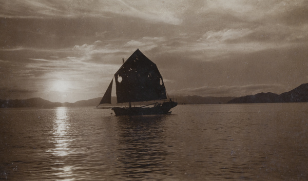 A picturesque view of a junk with a setting (or rising) sun, Hong Kong