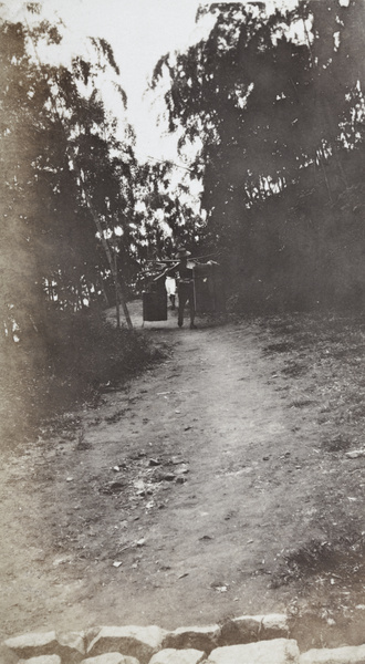 Food vendor carrying a portable kitchen along a track