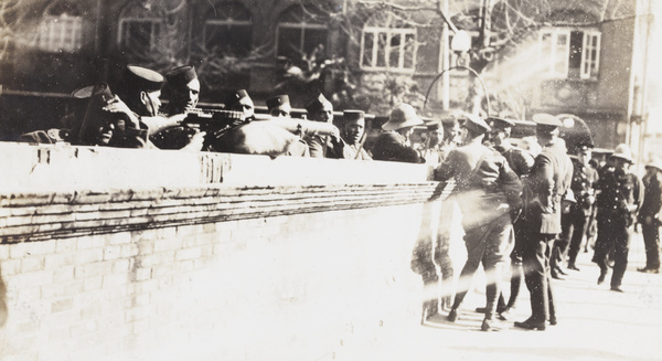 Soldiers and police beside a wall, Shanghai