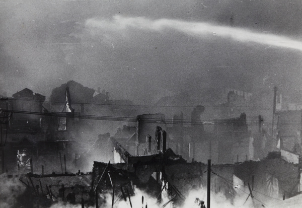 Hosing water to fight fires after bombing, Shanghai, 1937