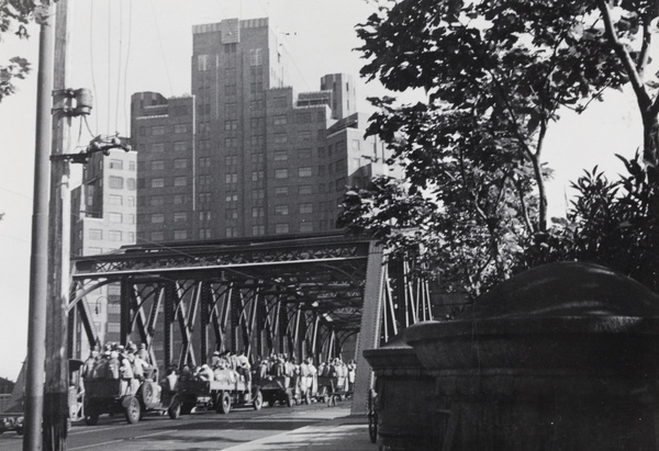 Convoy of Public Works Department labourers employed to clean up aftermath of bombing, Garden Bridge, Shanghai, 1937