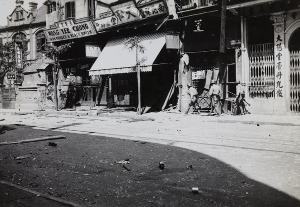 Three Japanese marines walking west along Range Road, Shanghai, 1937