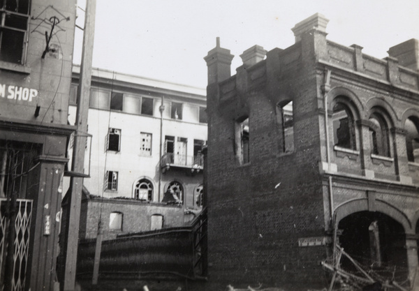 A Chinese soldier throwing a hand grenade, near the Pantheon Theatre, North Kiangse Road, Shanghai, 1937