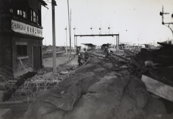 Japanese soldiers with a casualty on a stretcher, Shanghai North Railway Station, October 1937