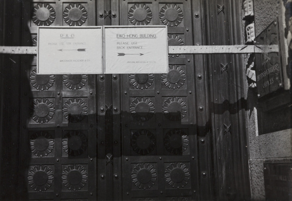 Signs in doorway to office building on the Bund, Shanghai, 1937