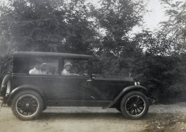 Geraldine Johns, with passengers, in an automobile