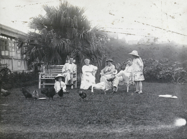 Group in a garden with hens and goose