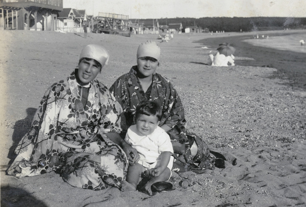Geraldine Johns, son Gerald, and another woman on a beach