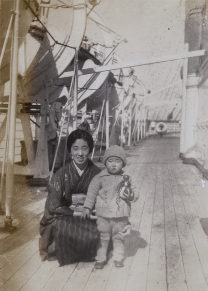 A woman and a child on the deck of a ship bound for Nagasaki