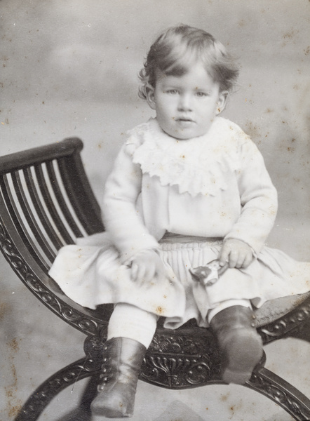George Leonard Alvan Dudeney holding a rattle