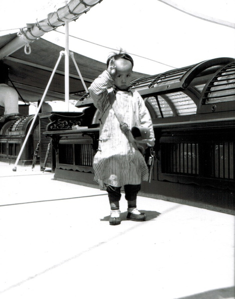 A boy with a pistol on a steamer, Haihe river, Tientsin