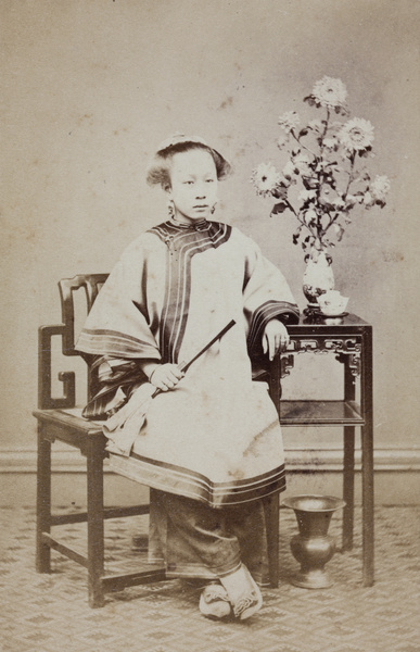 A woman with a fan and flowers