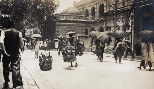 Porters carrying wood, outside Belilios Public School, Hollywood Road, Hong Kong