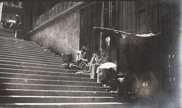 An umbrella repairer working beside a street, Hong Kong