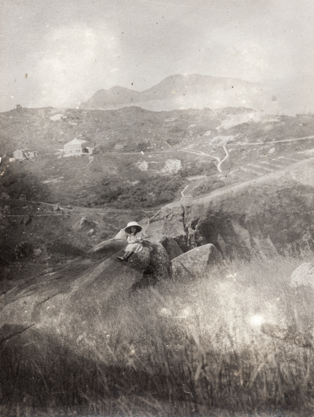 A girl sitting on a rock