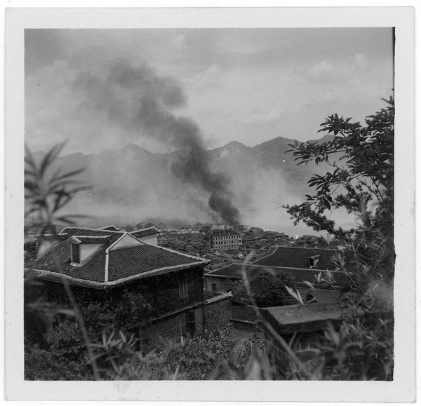 Steam/fumes clearing away and fires starting, after bombing, Chongqing