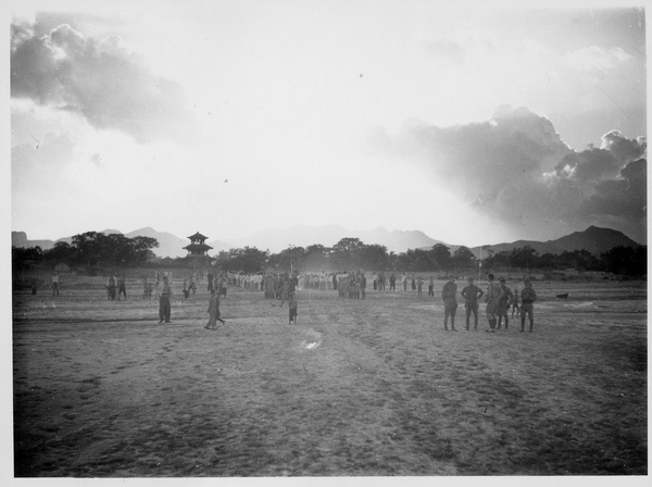 Soldiers on parade and spectators, with a pagoda in the background, Wanxian Zhan, Hebei, 1938