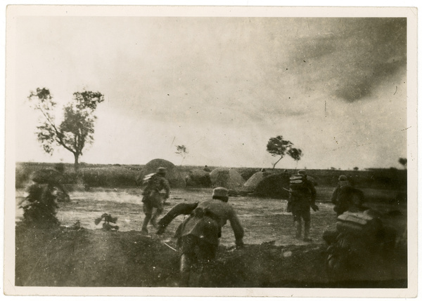 Eighth Route Army soldiers charging towards Japanese soldiers behind grave mounds, Central Hebei