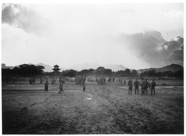 Soldiers on parade and spectators, with a pagoda in the background, Wanxian Zhan, Hebei, 1938