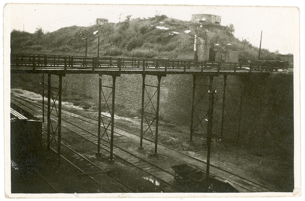 Pillboxes (military blockhouses) on a hill by a colliery bridge over railway tracks