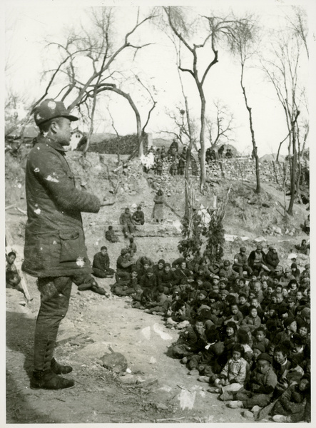 A man addressing children at an outdoor meeting, 1st Sub-district, Jinchaji