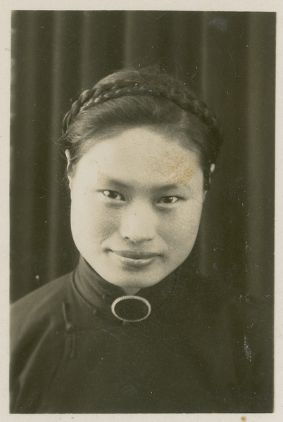 A portrait of Hsiao Li Lindsay (李效黎), with braided hair
