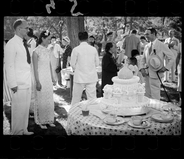 The Lindsays with Dr Rudolf Loewenthal, the best man, next to the wedding cake, at the Lindsay's wedding party at Yenching University (燕京大學), Beijing (北京)