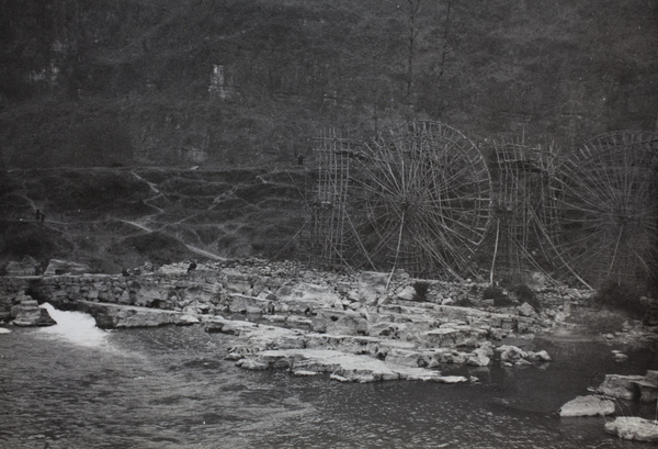 Waterwheels by a river