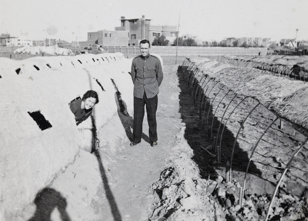 Rachel and Ian Morrison beside temporary emergency shelters, Tianjin floods, September 1938