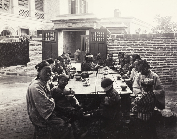 Women and children eating a meal at the Womens' Hospital, Xiamen