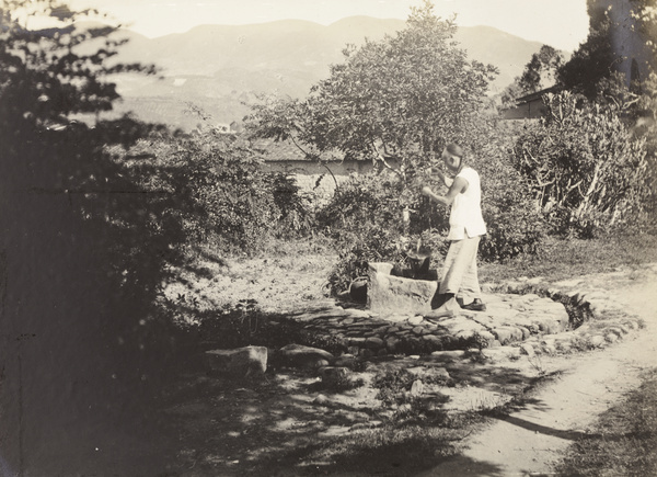 A man drawing water from a well, Fujian province