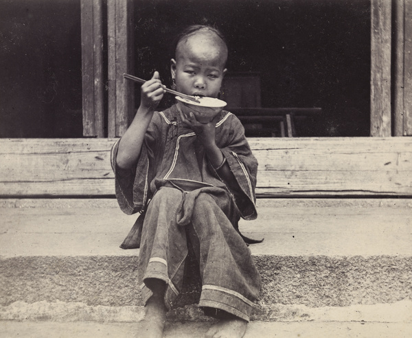 A girl showing how to eat rice with chopsticks