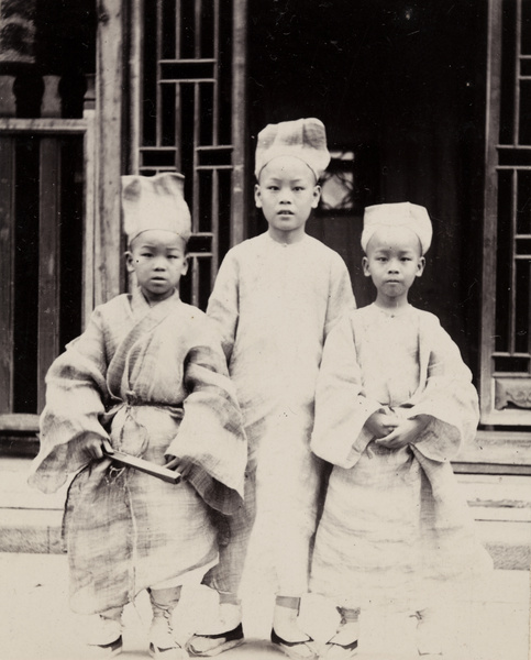 Three boys wearing mourning clothing