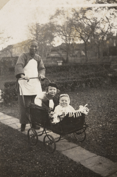 An amah with the Logan Roots children in a pram