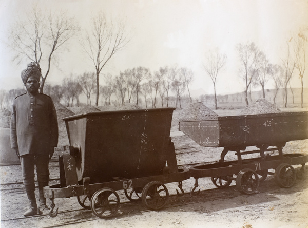 Sikh soldier, with railway wagons showing measurements