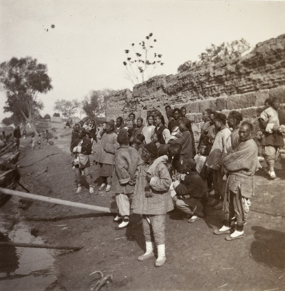 Interested spectators beside moored boats