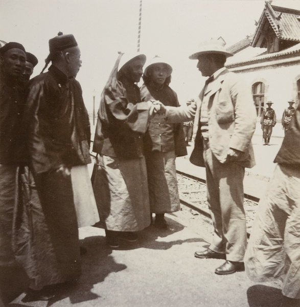 British Commissioner and General Mei bid farewell at a railway station