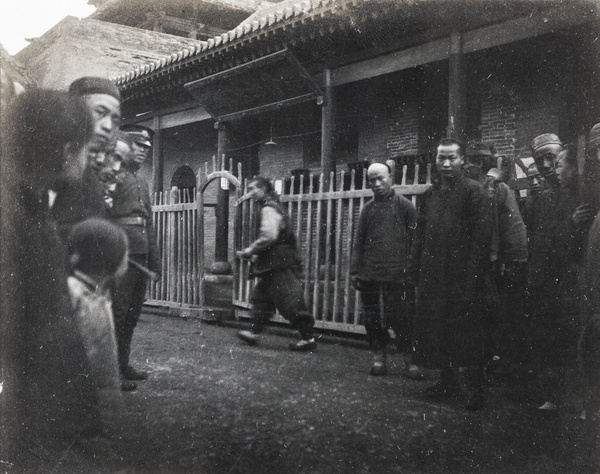 Crowd and policeman outside a building