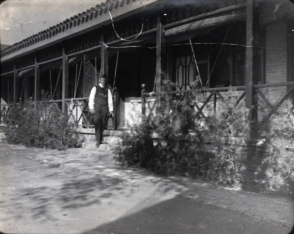 Oliver H. Hulme outside a house