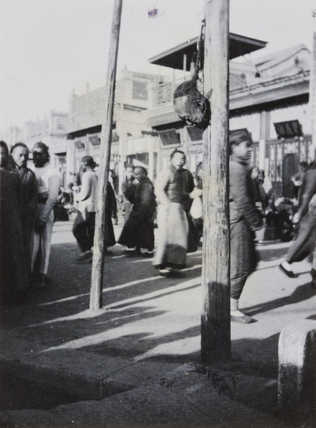 Exposed severed head of looter, Peking, 1912