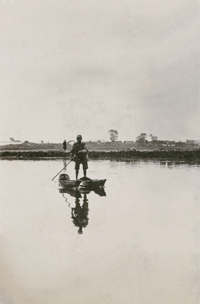 Fisherman with a craft of two boats fastened together