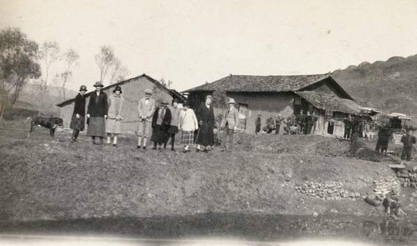 Day trippers, with chair bearers, in a village