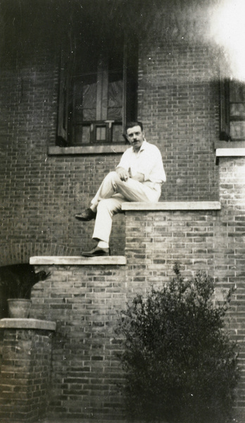 Attwell Lynch Palmer sitting outside a house, Shanghai